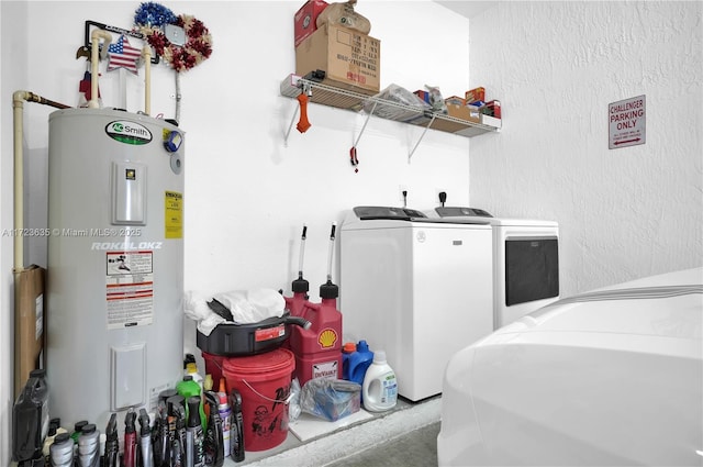 washroom with water heater and washing machine and clothes dryer