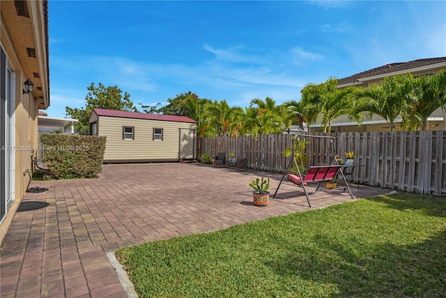 view of yard with a storage shed and a patio area