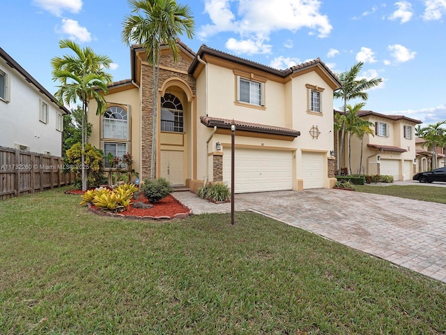 mediterranean / spanish home with a garage and a front lawn