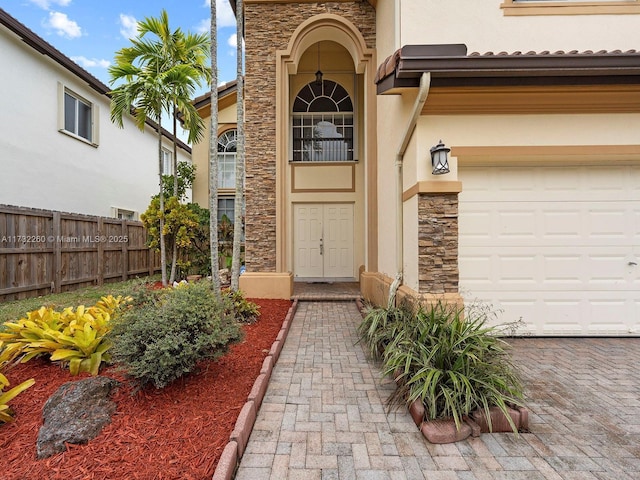 view of exterior entry featuring a garage