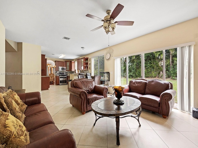 tiled living room featuring ceiling fan