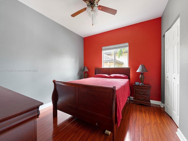 bedroom featuring dark hardwood / wood-style flooring, a closet, and ceiling fan