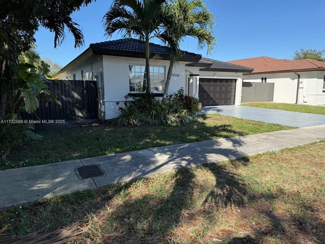 view of front of property with a garage and a front lawn