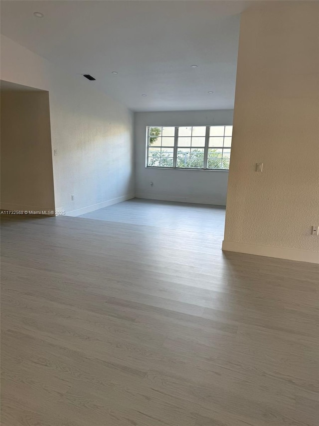 spare room featuring light wood-type flooring