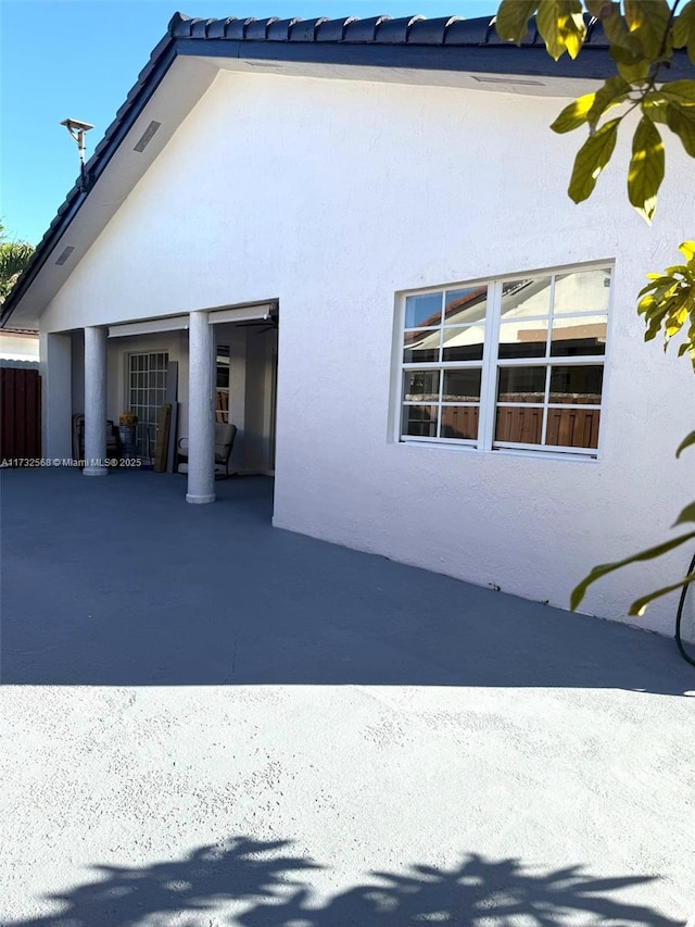 view of side of property with a patio area