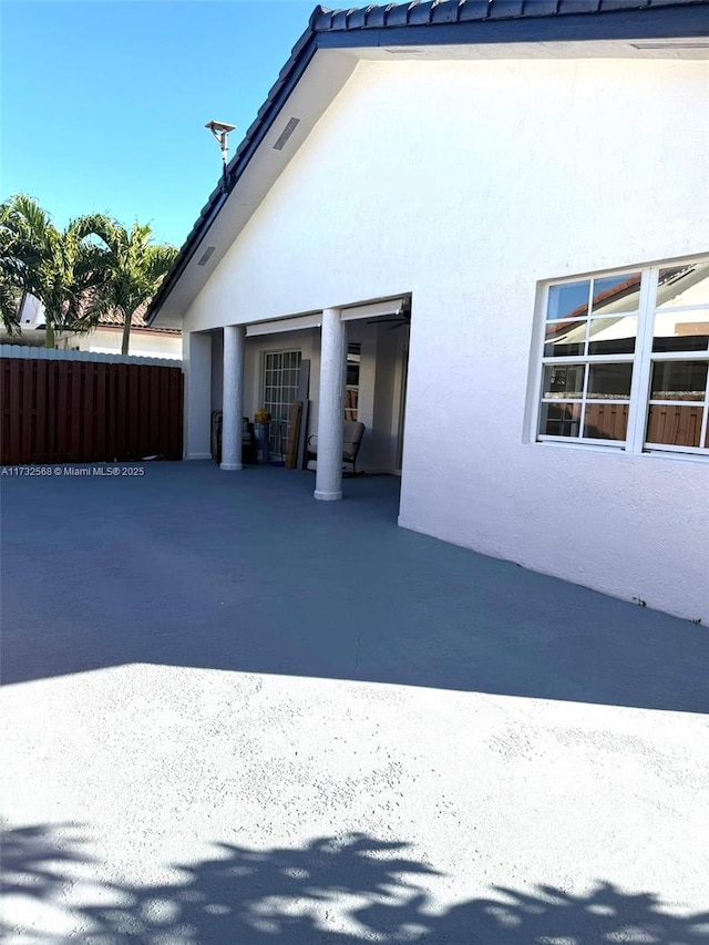 view of side of home with a patio