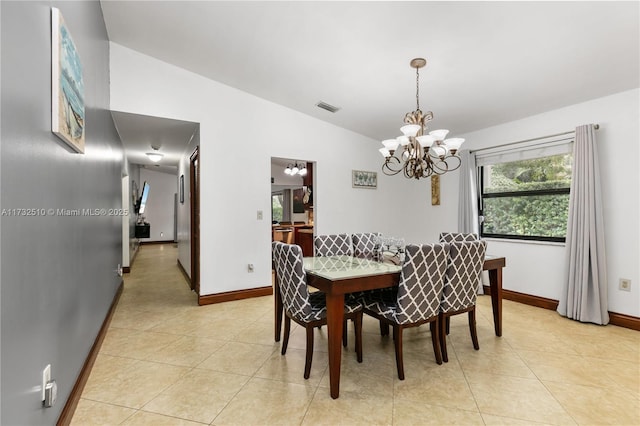 dining area with vaulted ceiling, light tile patterned flooring, visible vents, and baseboards