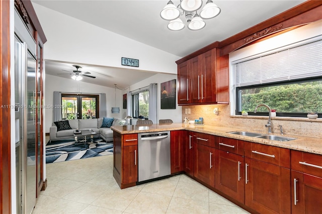 kitchen featuring light stone counters, open floor plan, vaulted ceiling, stainless steel dishwasher, and a sink