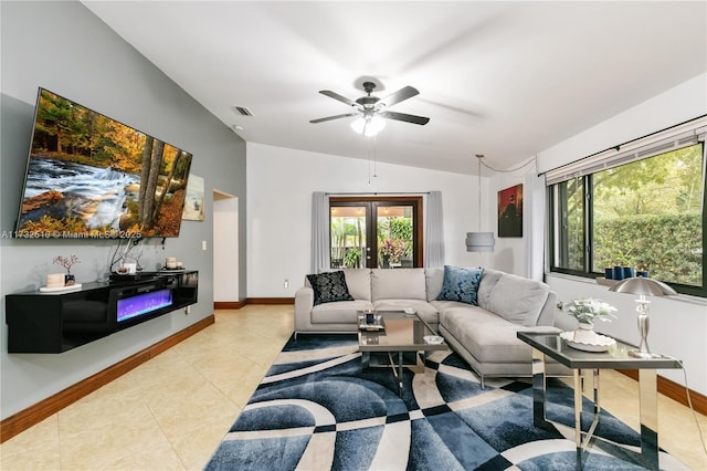 living area with lofted ceiling, french doors, light tile patterned flooring, and baseboards