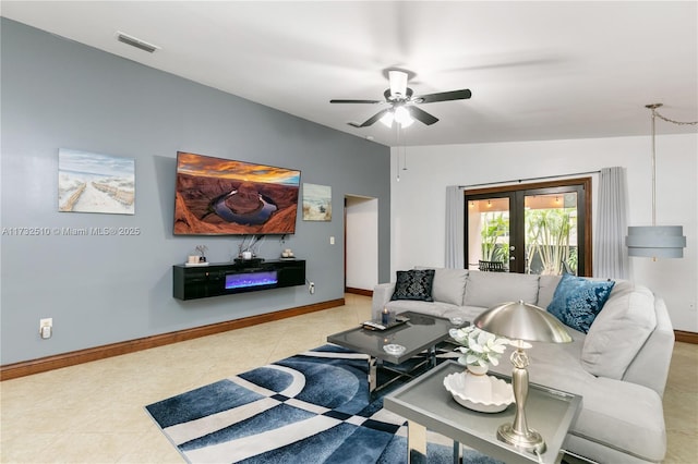 tiled living area with a ceiling fan, french doors, visible vents, and baseboards