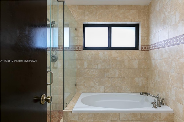 bathroom with a stall shower and a bath