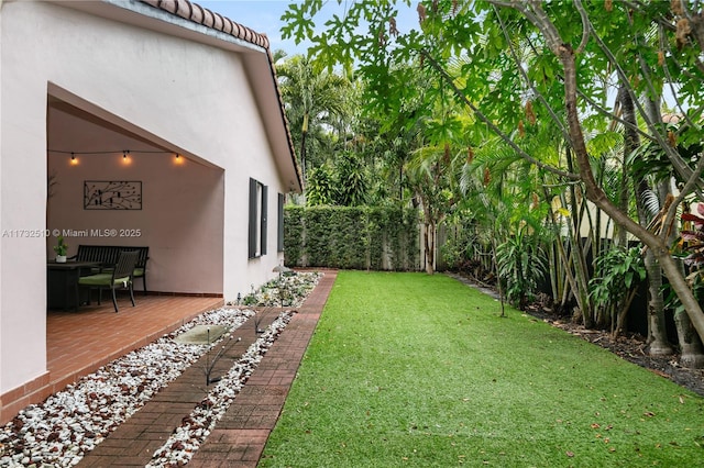 view of yard featuring a patio area and fence