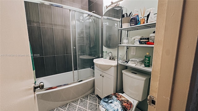 full bathroom featuring tile patterned flooring, enclosed tub / shower combo, vanity, and toilet