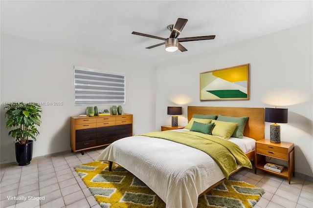 bedroom featuring light tile patterned floors, ceiling fan, and baseboards