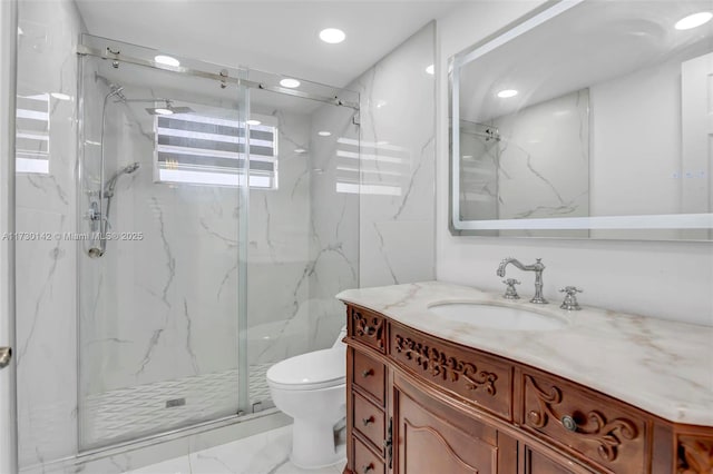 full bathroom with marble finish floor, a marble finish shower, recessed lighting, toilet, and vanity