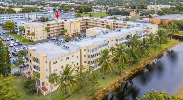 birds eye view of property featuring a view of city and a water view