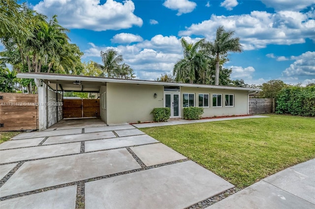 view of front facade with a carport and a front yard