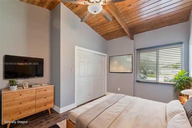 unfurnished bedroom with wood ceiling, dark wood-type flooring, ceiling fan, lofted ceiling with beams, and a closet