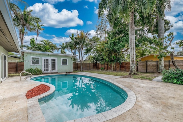 view of swimming pool featuring french doors and a patio area