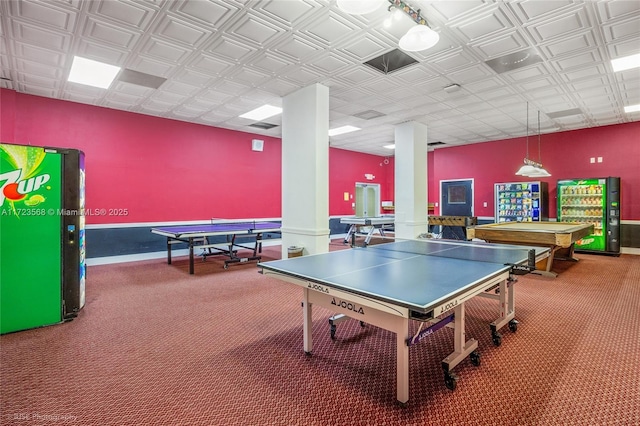 recreation room with decorative columns and carpet floors