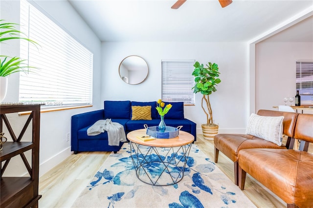 living room featuring light hardwood / wood-style floors and ceiling fan