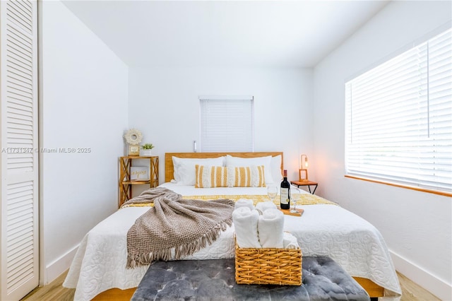 bedroom with hardwood / wood-style floors and a closet