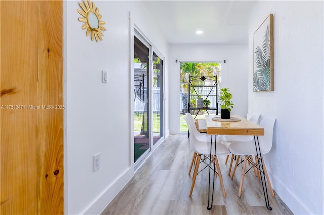 dining space with light hardwood / wood-style floors