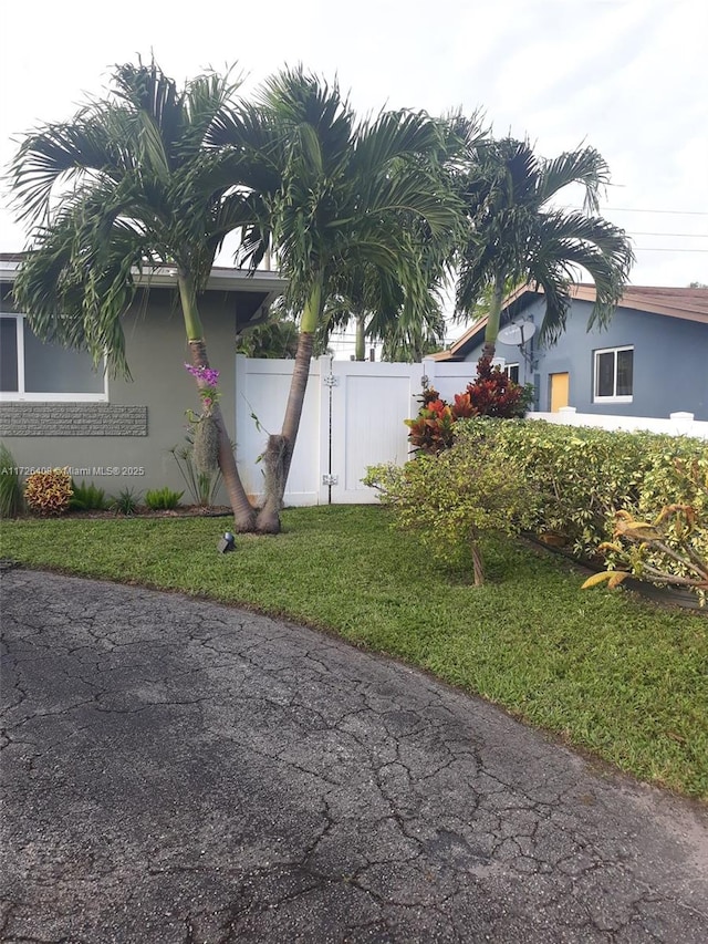 view of property exterior with a yard