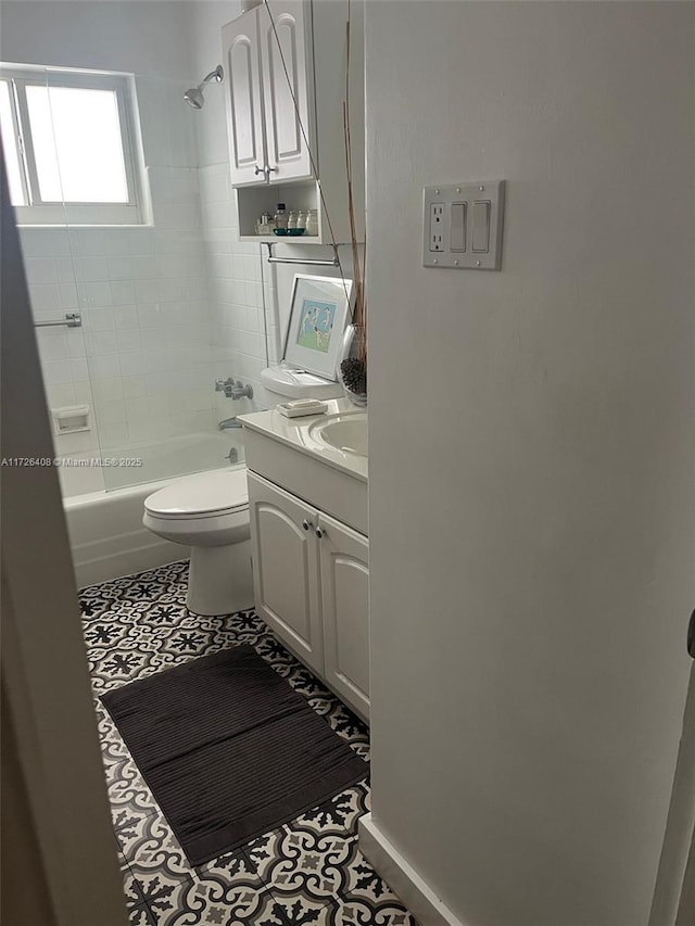 full bathroom with tile patterned floors, toilet, tiled shower / bath combo, and vanity