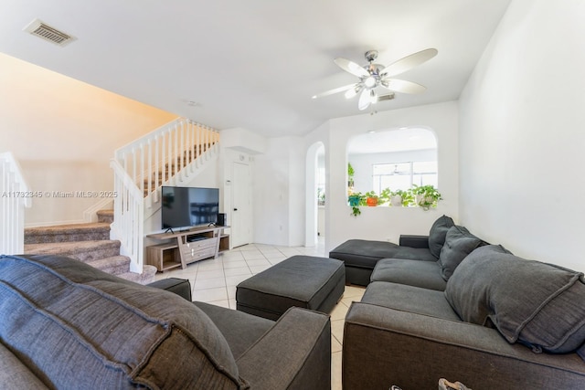 living room featuring light tile patterned floors and ceiling fan