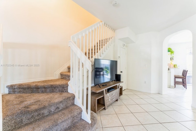 staircase featuring tile patterned floors