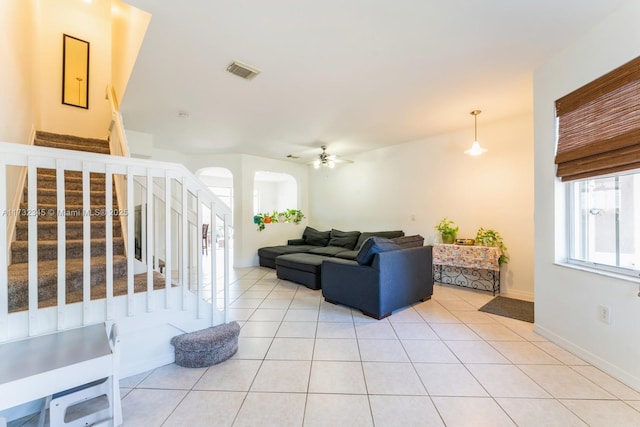 living room featuring light tile patterned floors and ceiling fan