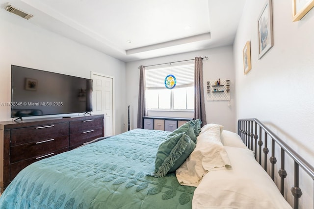 bedroom featuring a raised ceiling