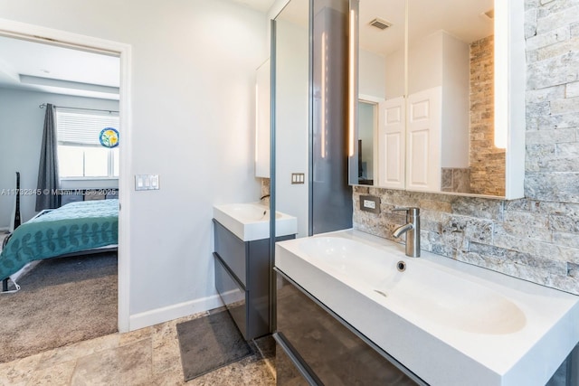 bathroom featuring vanity and decorative backsplash