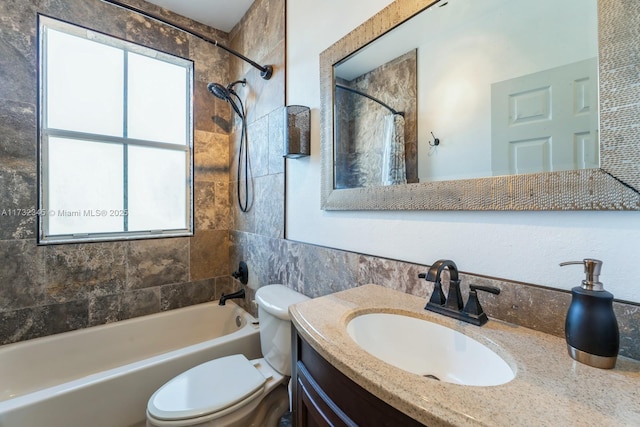 full bathroom with tiled shower / bath combo, vanity, and toilet