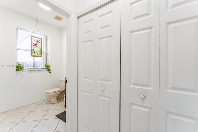 bathroom with tile patterned flooring and toilet