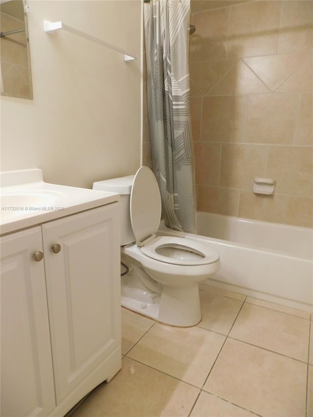 full bathroom featuring vanity, tile patterned floors, toilet, and shower / bath combo with shower curtain