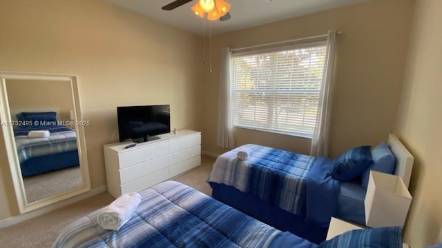 bedroom featuring ceiling fan and light carpet