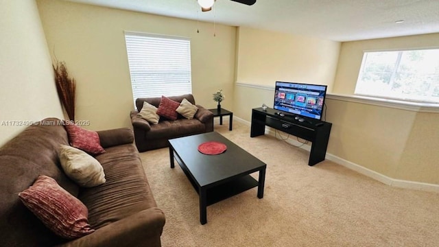 living room featuring light carpet and ceiling fan