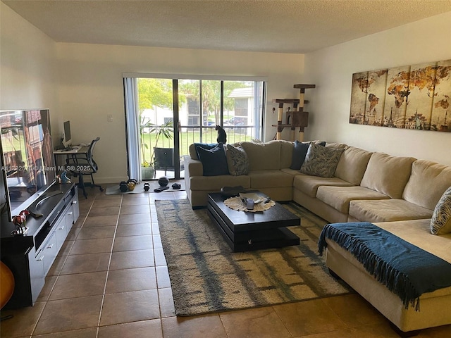 living room with dark tile patterned floors and a textured ceiling