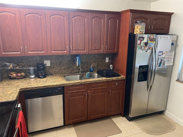 kitchen with stainless steel appliances, light tile patterned flooring, sink, and tasteful backsplash