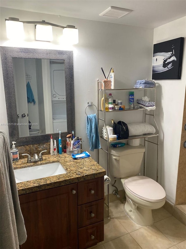 bathroom featuring tile patterned flooring, vanity, and toilet