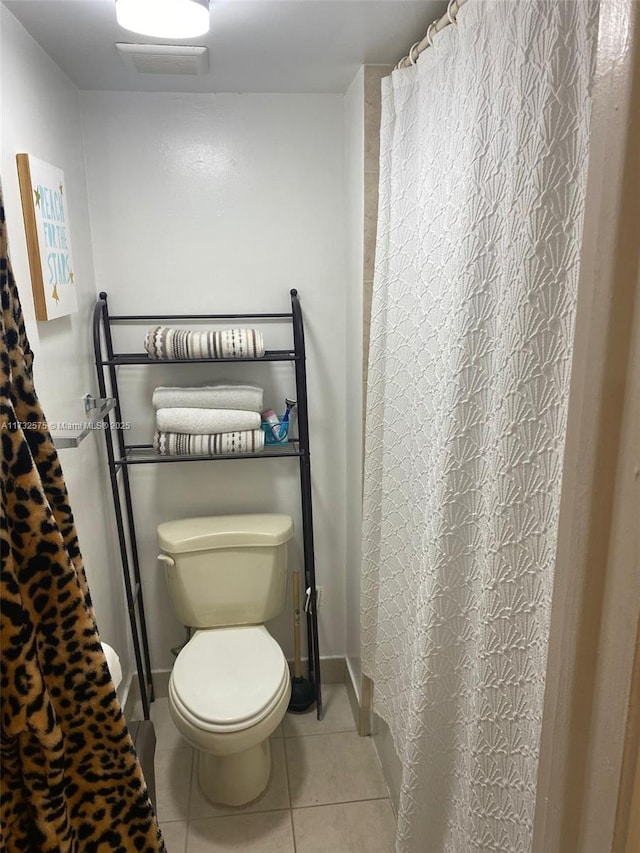 bathroom with tile patterned flooring and toilet