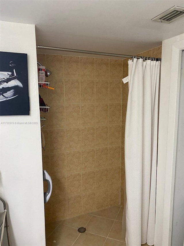 bathroom featuring tile patterned flooring and a shower with curtain