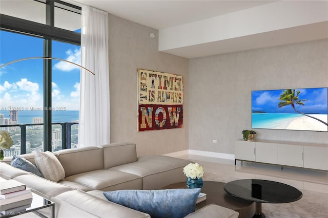 living room with expansive windows and a water view