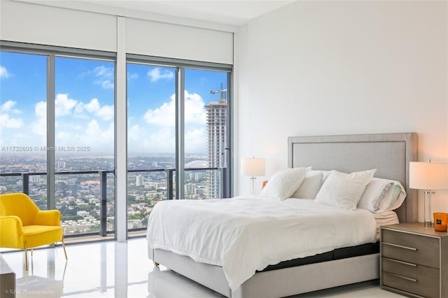 bedroom with a wall of windows and multiple windows