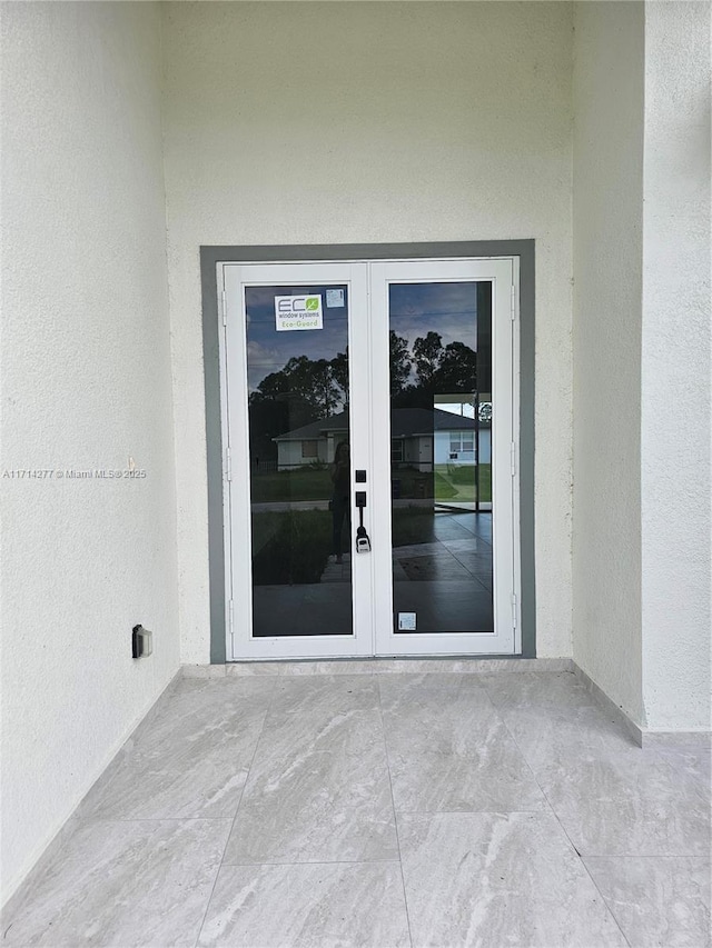 entrance to property featuring french doors