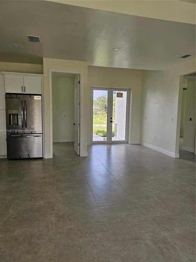 unfurnished living room with french doors