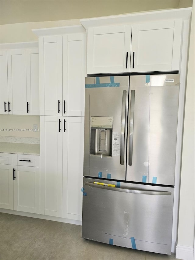 kitchen with white cabinets and stainless steel fridge with ice dispenser