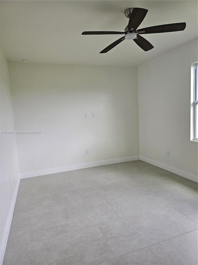 spare room featuring light tile patterned floors and ceiling fan